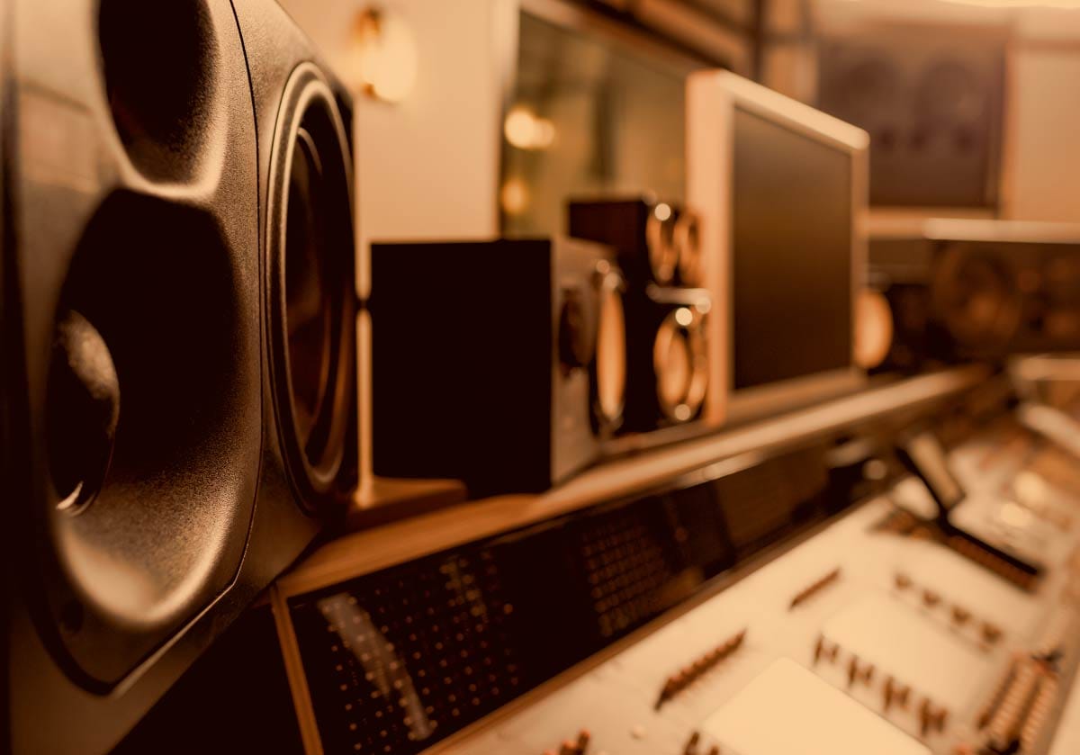 Professional studio monitor speaker set up on a mixing console in a recording studio