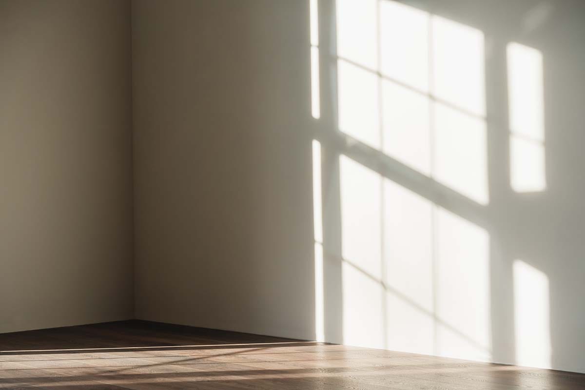 Empty corner of a home studio room showing bare drywall junction where low-frequency bass buildup occurs