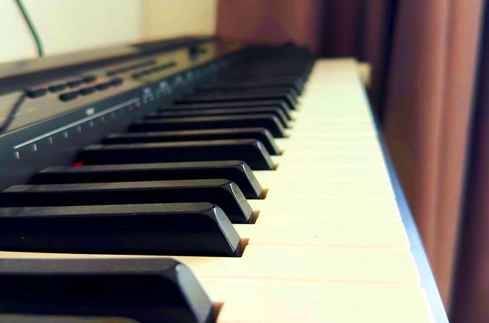 Close-up view of full-sized weighted piano keys on an 88-key electronic keyboard controller