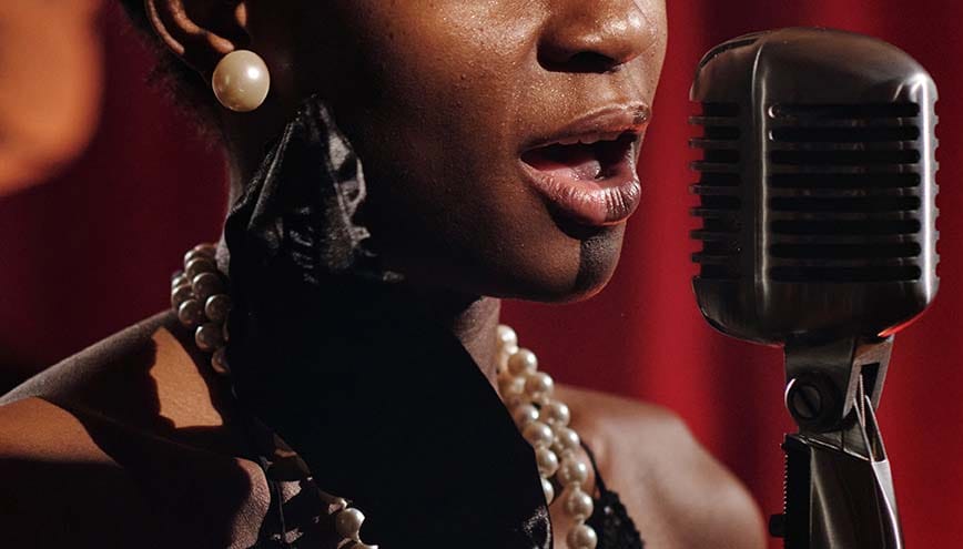 A female singer sings into a microphone.
