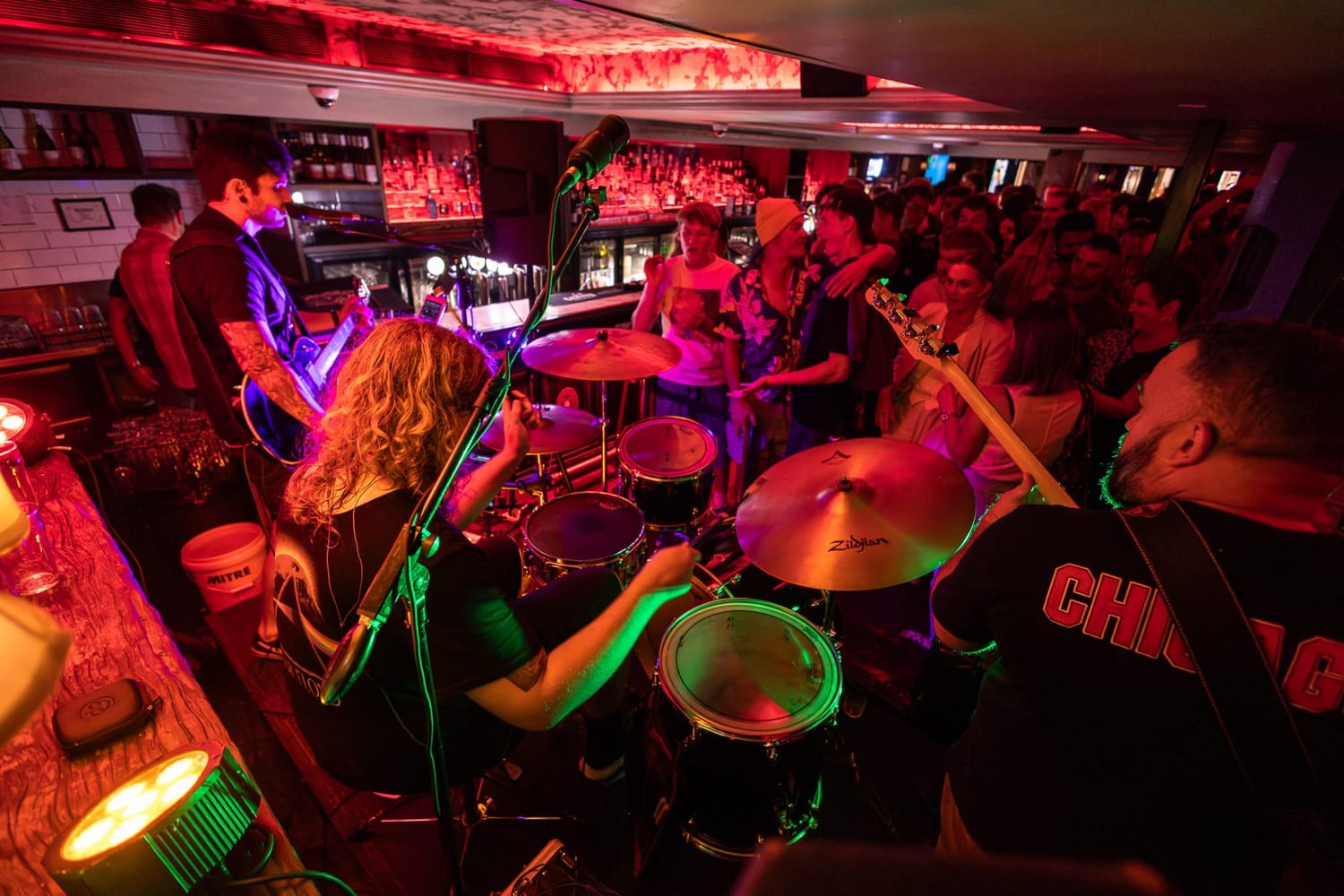 A full band performing for a packed pub crowd