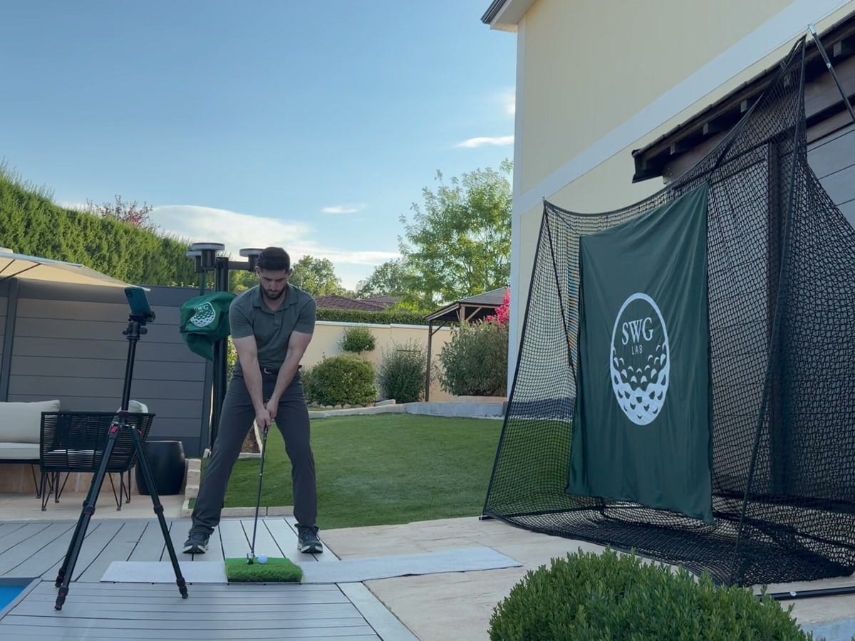 The Practice Net set up by the pool, golfer at address