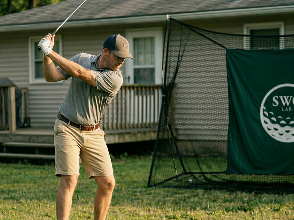 The Practice Net standing in a backyard as a golfer swings