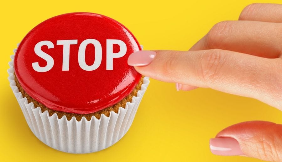 A cupcake topped with a red STOP button