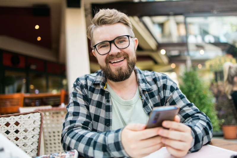 Man smiling at his phone