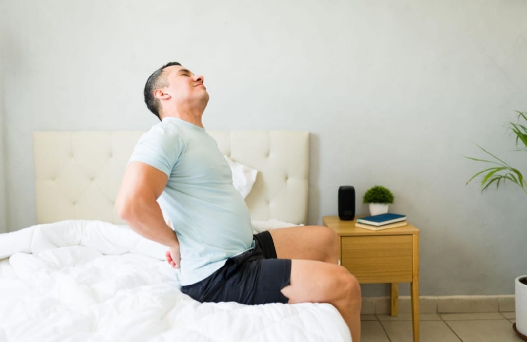 Person waking up with lower back pain