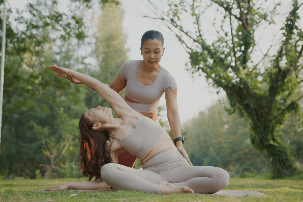 Wellness professional guiding a client outdoors