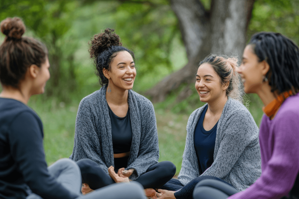 Women sitting together outdoors in conversation