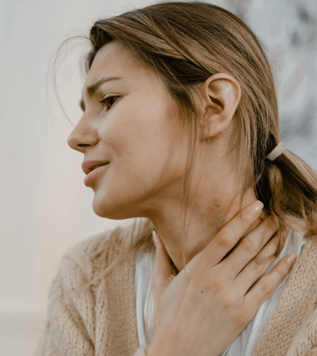 woman looking stressed and holder her neck