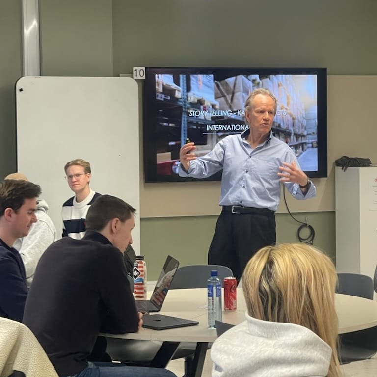 Entrepreneurship lecture in a classroom: instructor presenting a practical framework