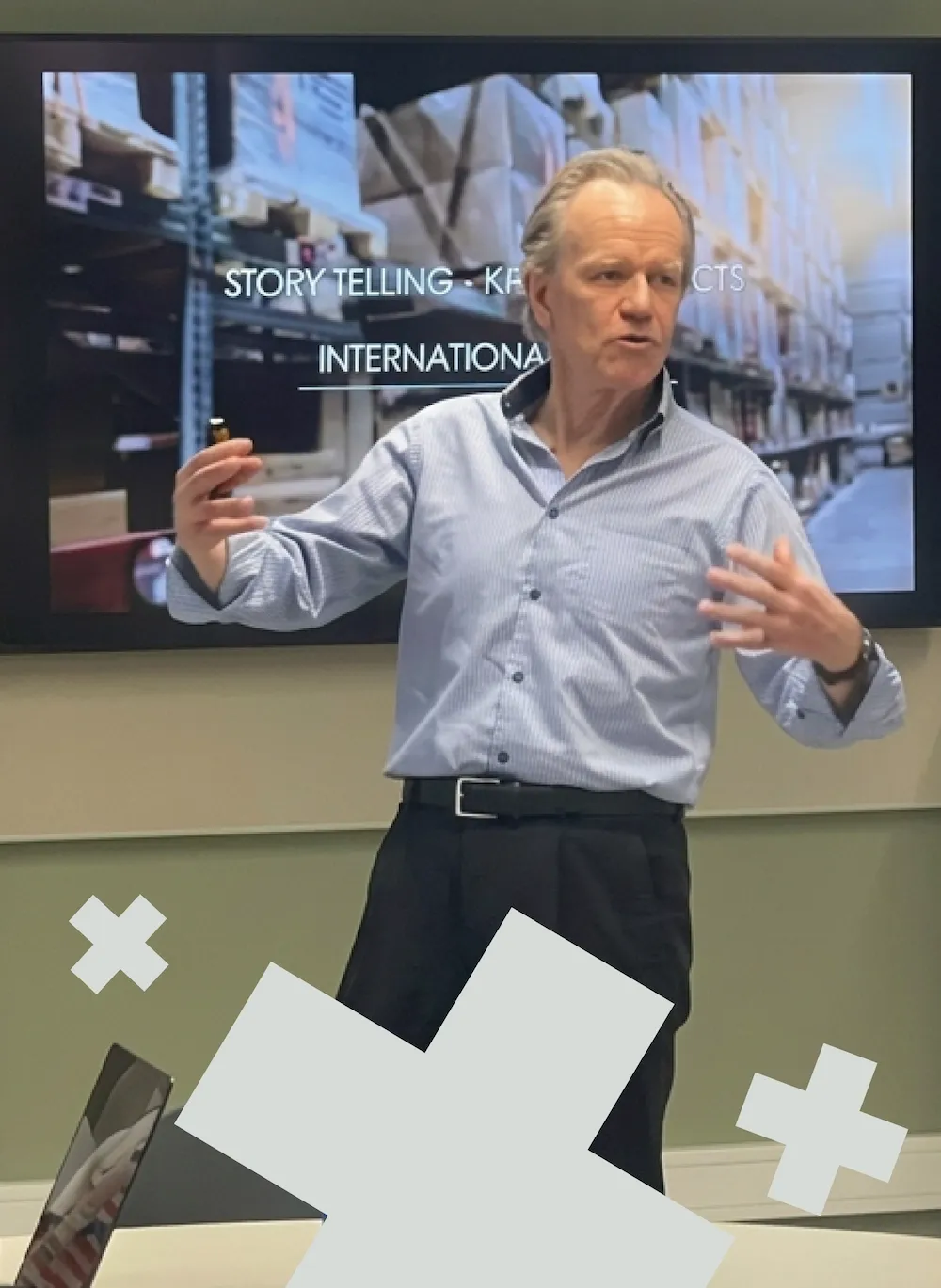 Business lecturer presenting in front of a screen during a classroom session