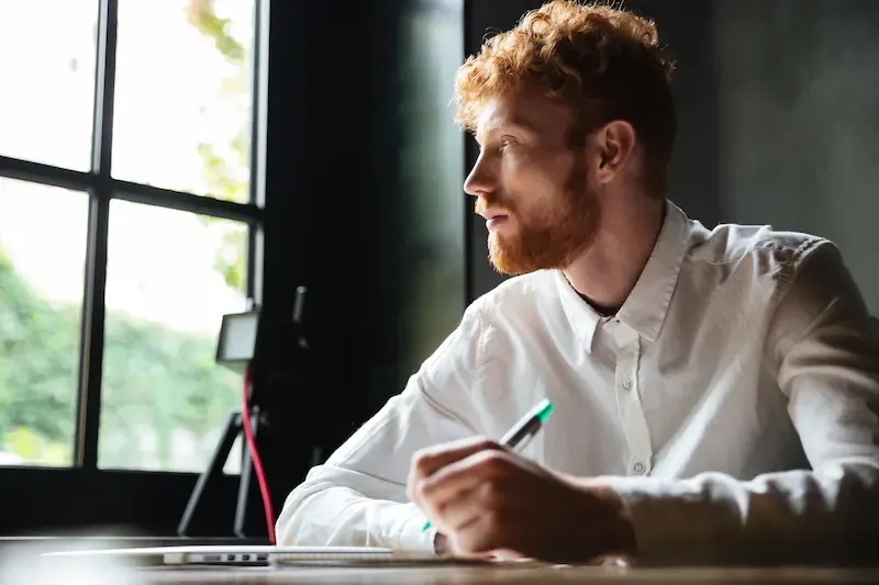 entrepreneur preparing investor pitch answers writing notes before meeting