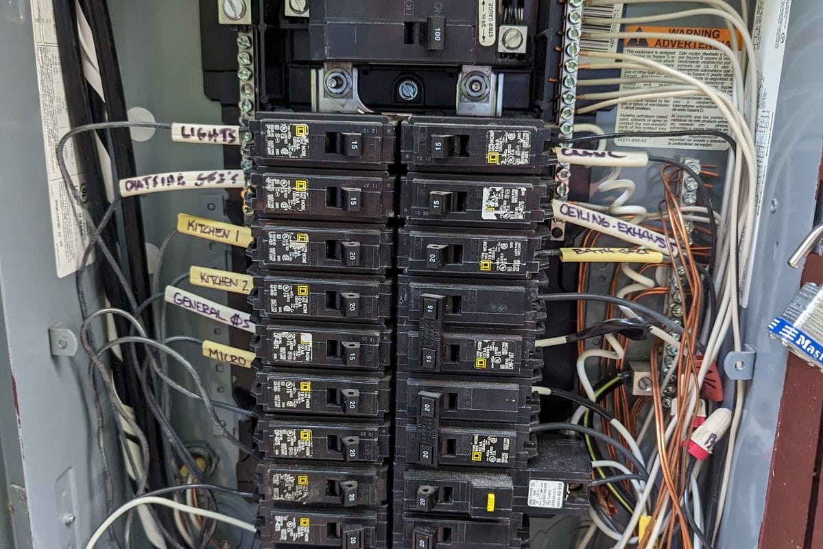 A residential electrical panel with rows of circuit breakers
