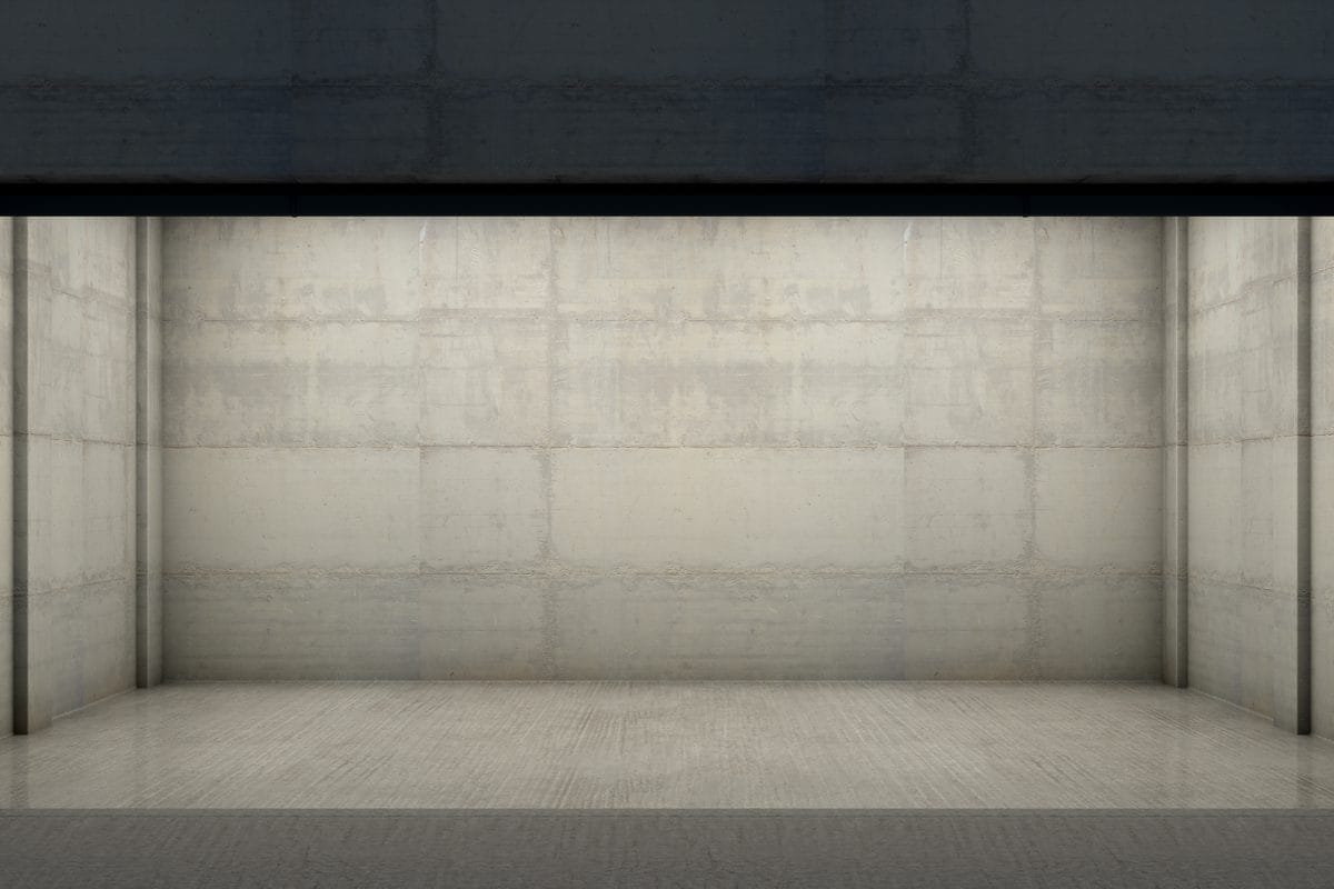 An empty garage with a concrete slab floor