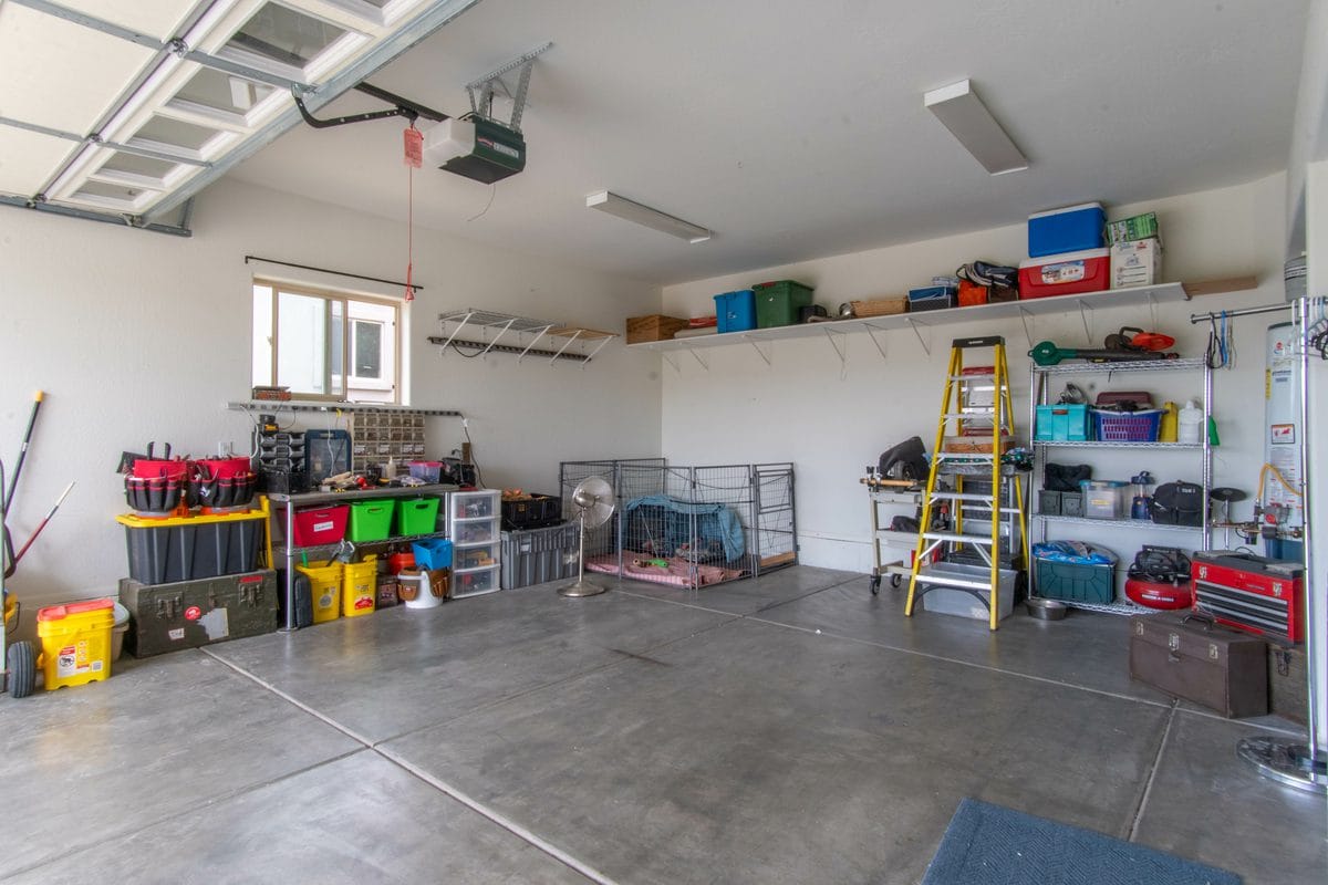 A two-car garage with shelves and storage along the walls