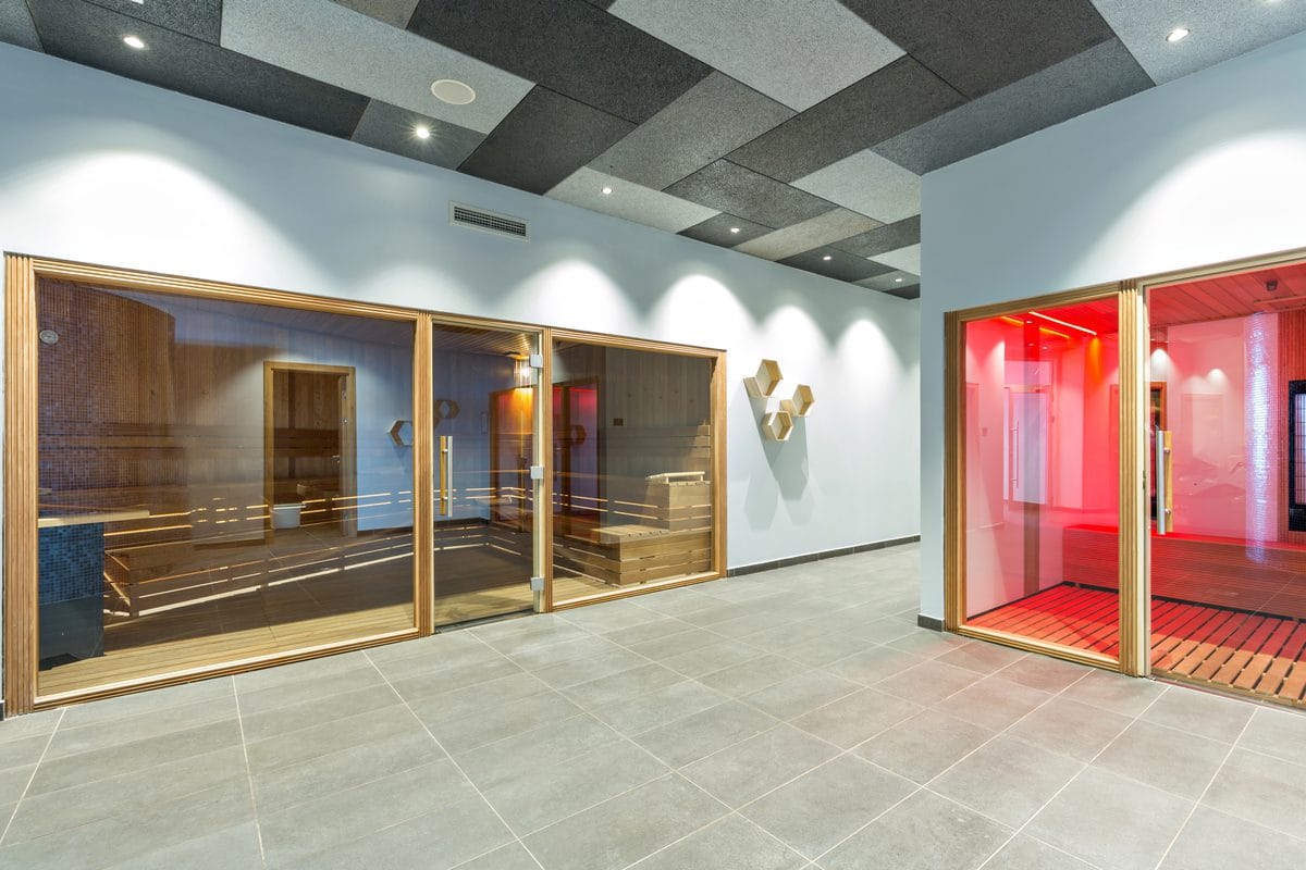 Glass-fronted infrared sauna rooms in a spa