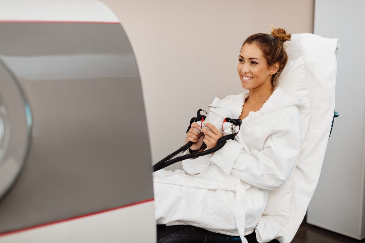 A woman seated in a hyperbaric chamber