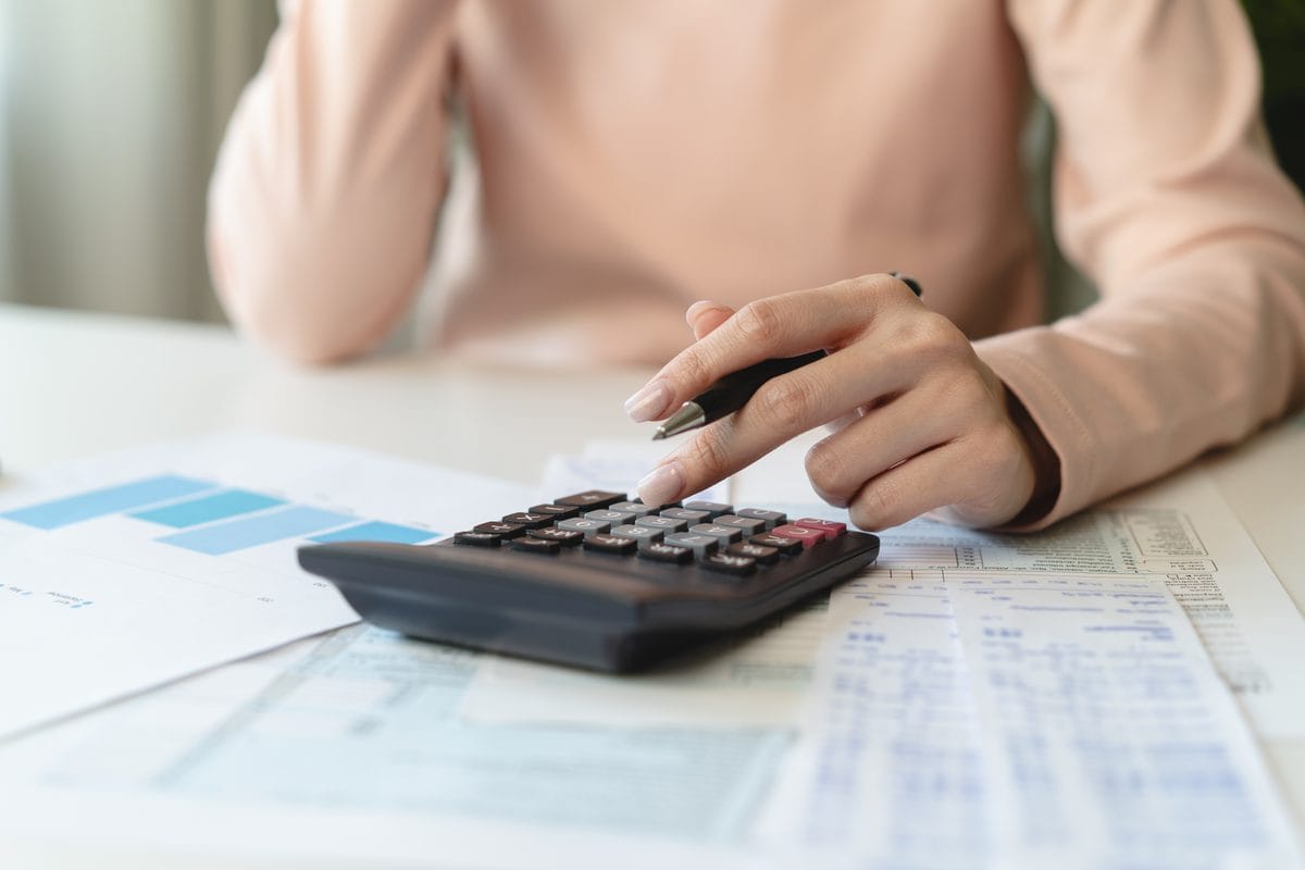 A person working through bills with a calculator