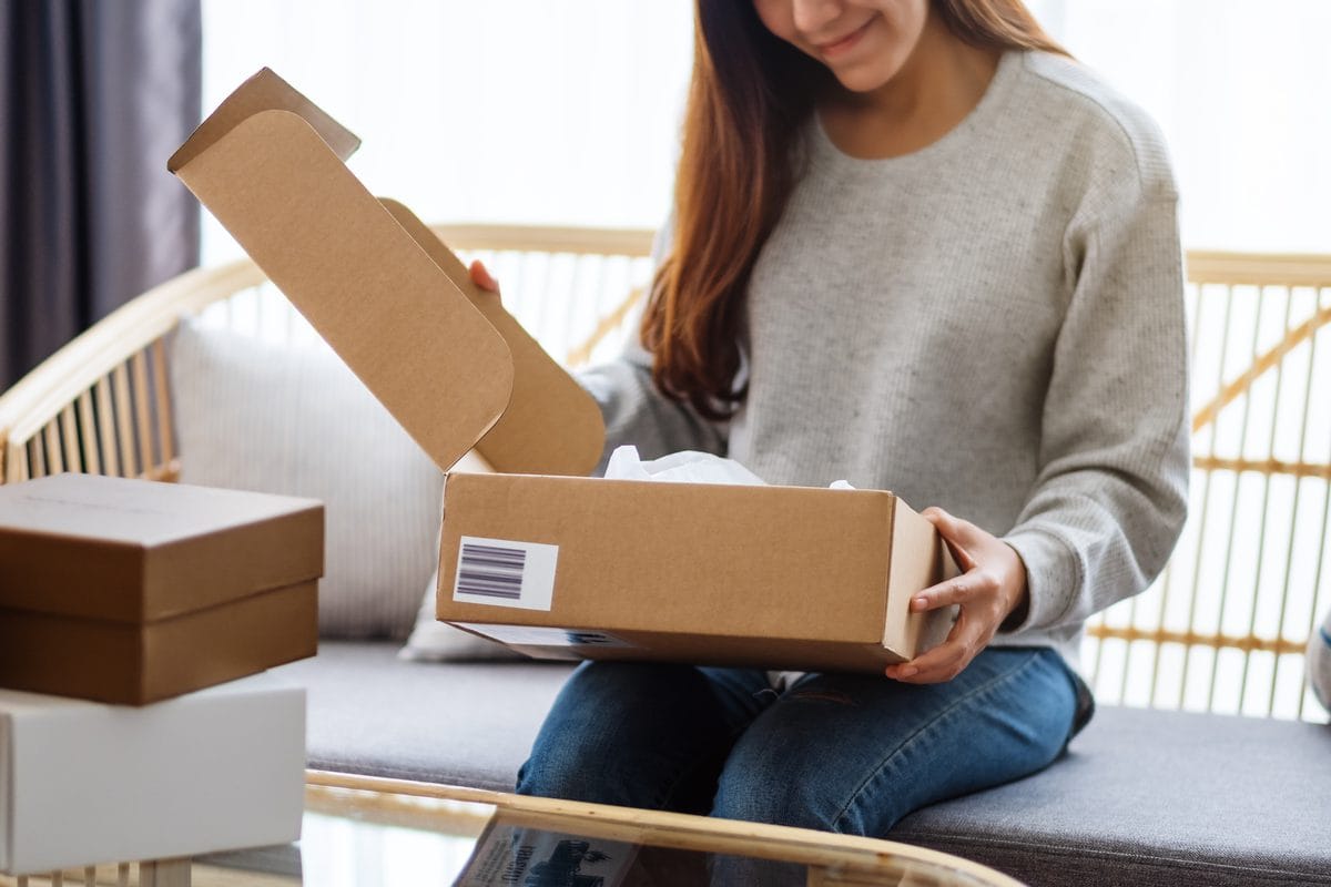 A woman opening a delivery box at home