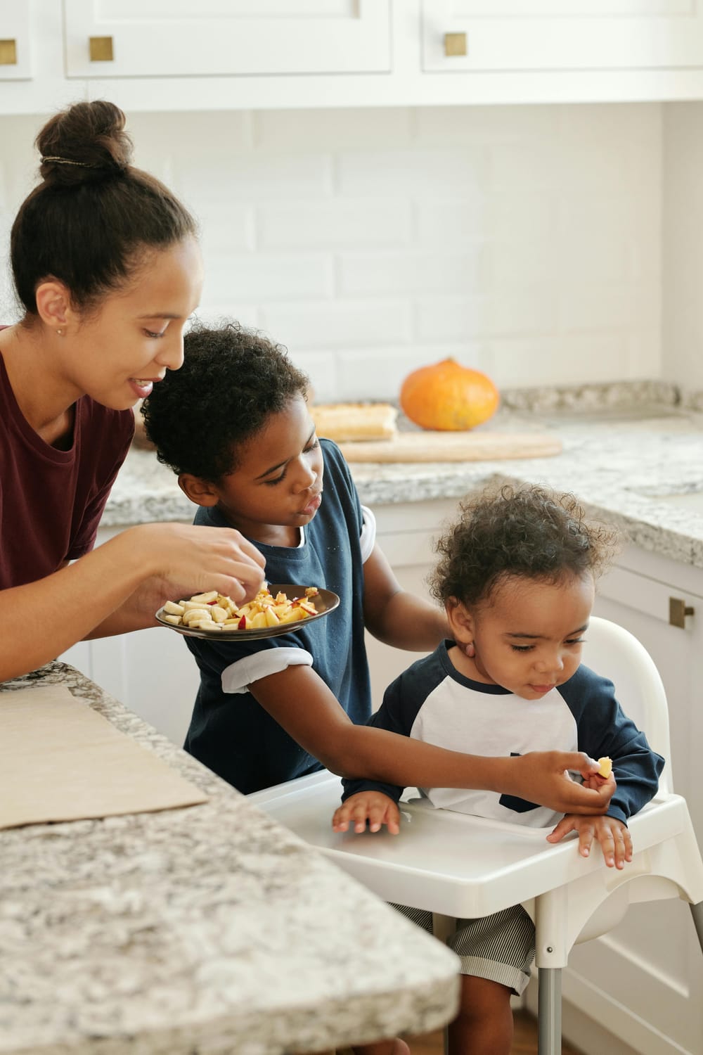 mother eating apple with her kids