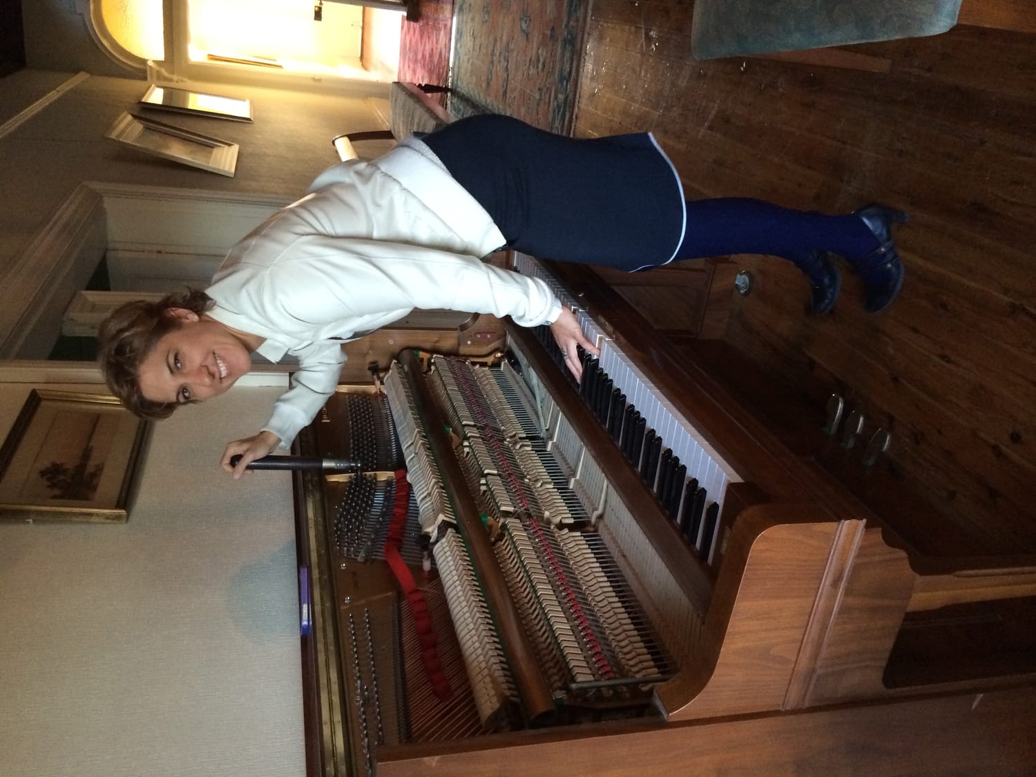 woman tuning upright piano