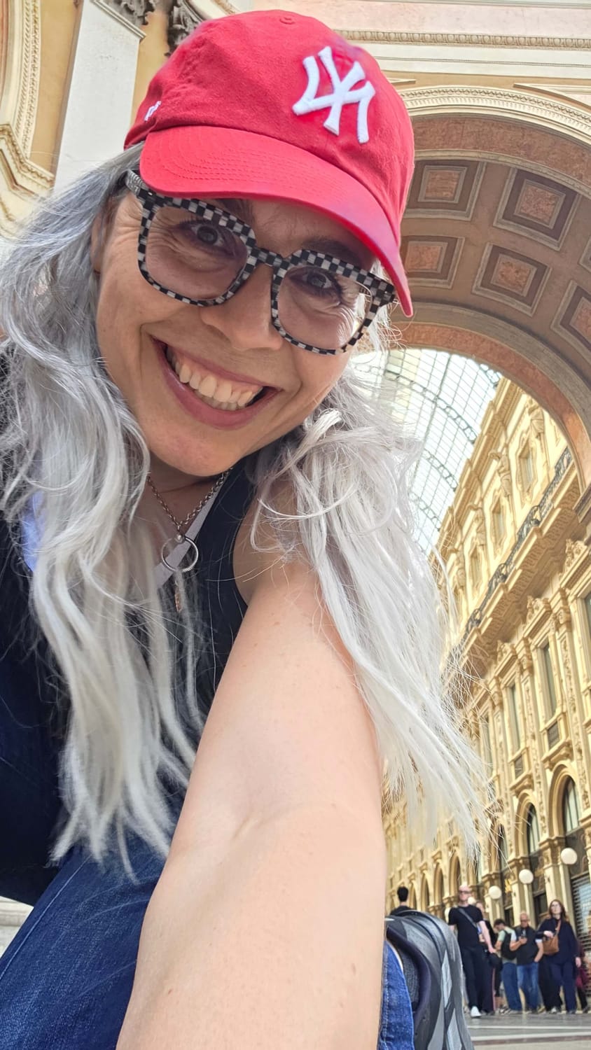Kay smiling in a red cap