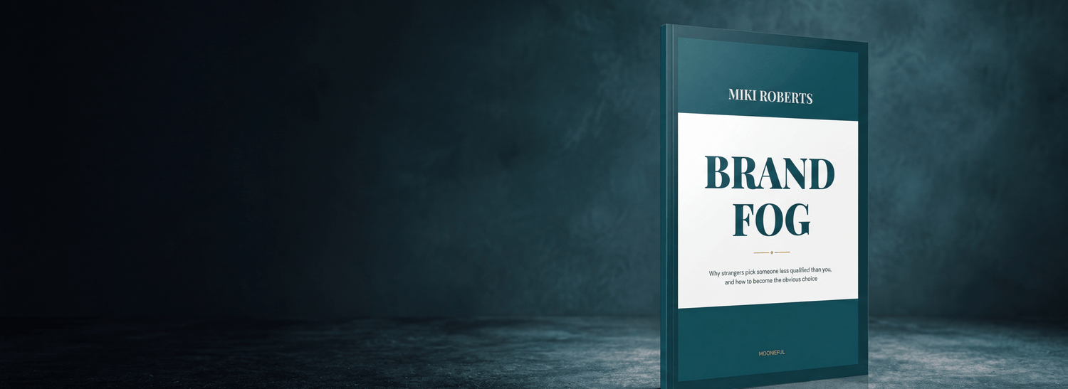 The Brand Fog book standing upright against a dark studio backdrop