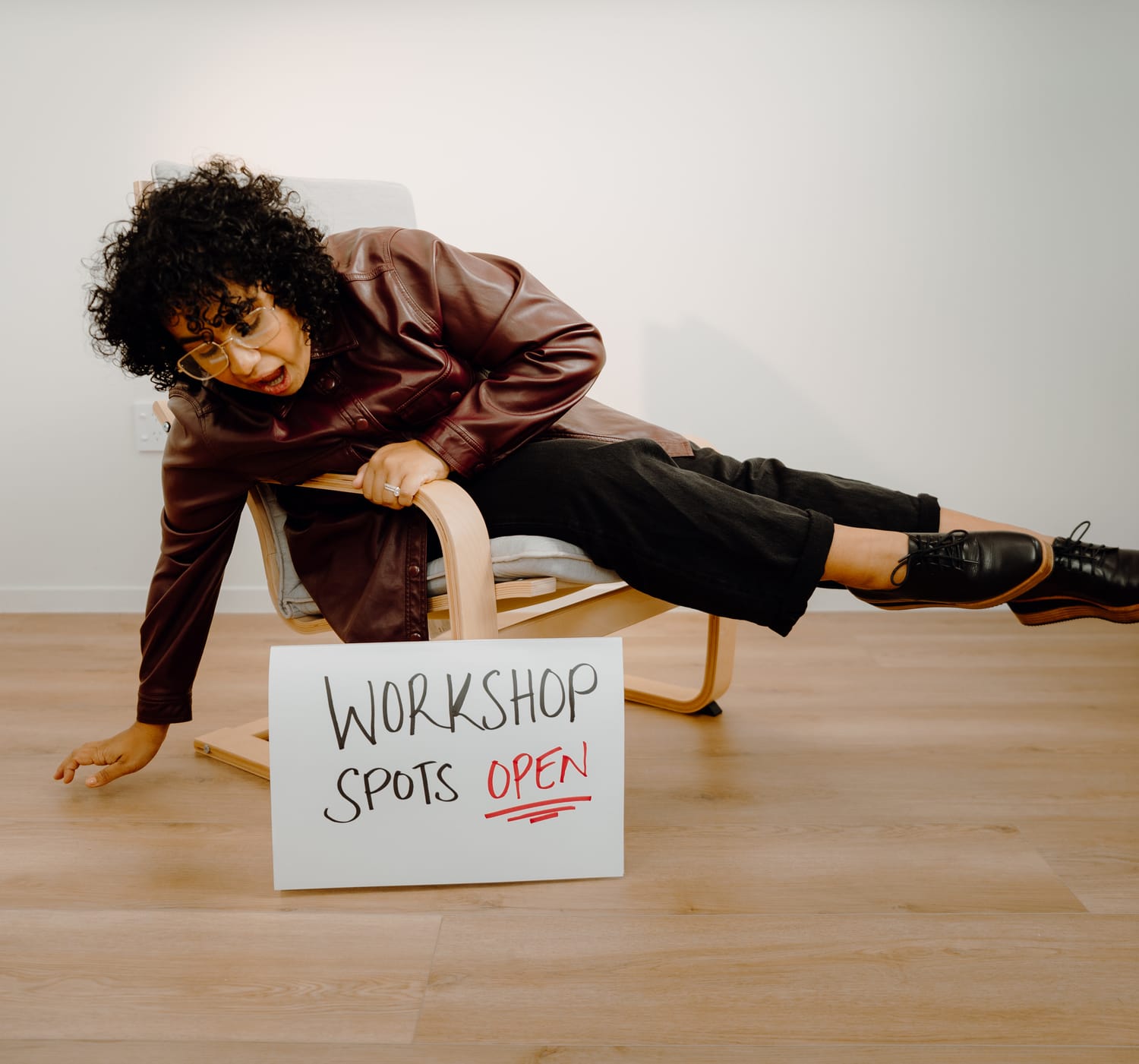 Sanam Permal with a Workshop Spots Open sign