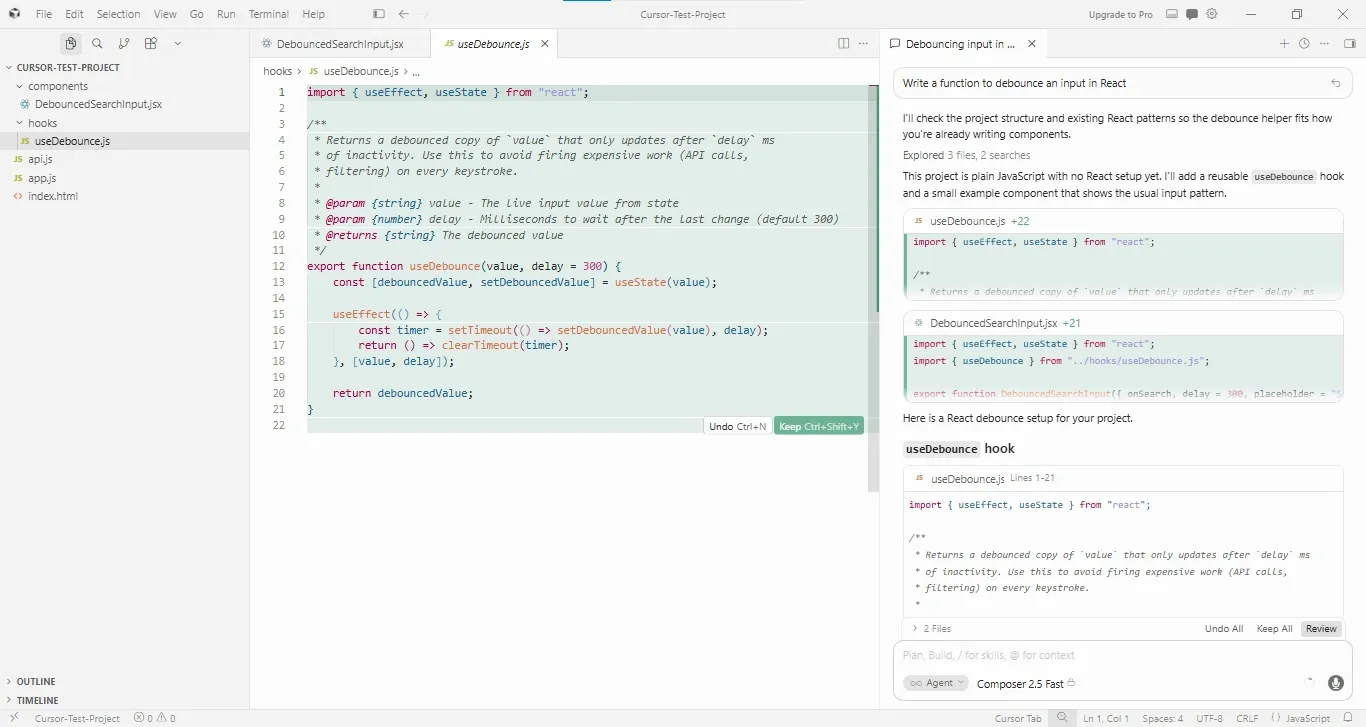 Screenshot of the Cursor editor in a light theme with a project named “CURSOR-TEST-PROJECT” open. The project explorer shows folders named components and hooks, along with files including DebouncedSearchInput.jsx, useDebounce.js, api.js, app.js, and index.html. The useDebounce.js file is open and displays a React custom hook implementation. The code imports useEffect and useState from React, includes JSDoc comments describing a debounced value helper, and defines a useDebounce(value, delay = 300) function that updates state after a timeout and clears the timer on cleanup.  On the right side, a chat panel titled “Debouncing input in React” shows the user’s request: “Write a function to debounce an input in React.” The AI response explains that it reviewed the project structure and generated a reusable useDebounce hook along with a sample DebouncedSearchInput.jsx component. Code changes are displayed as editable suggestions, with controls to review, keep, or undo the proposed edits. The interface indicates that multiple files were explored and modified as part of the response.