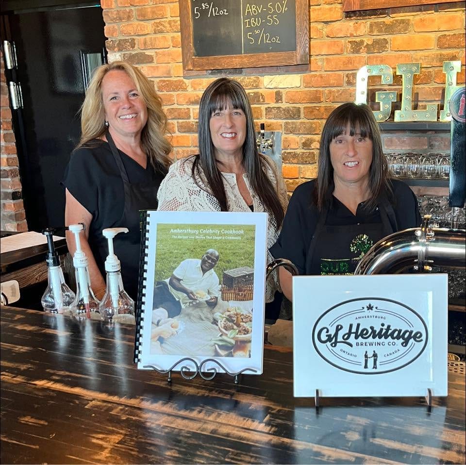 Our Recipe Tree project team with the printed 119-page Celebrity Recipe Book created for the Amherstburg Food and Fellowship Mission