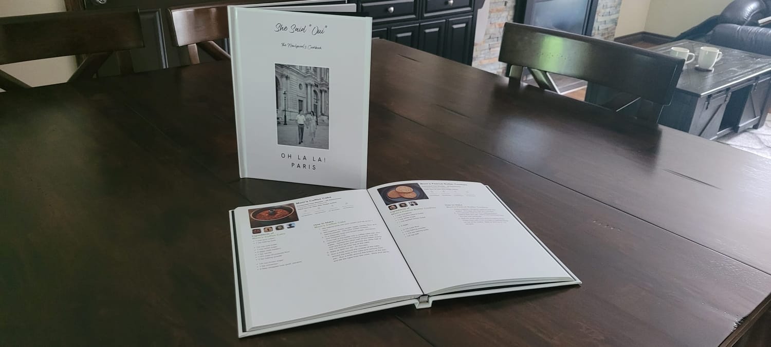 An actual hardcover Recipe Book created with Our Recipe Tree, beside an open printed copy showing recipe pages.
