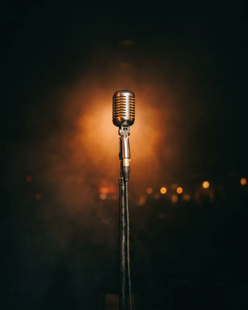 Vintage stage microphone in warm spotlight