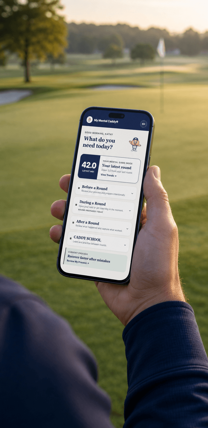 Golfer holding the My Mental Caddy® app on the golf course