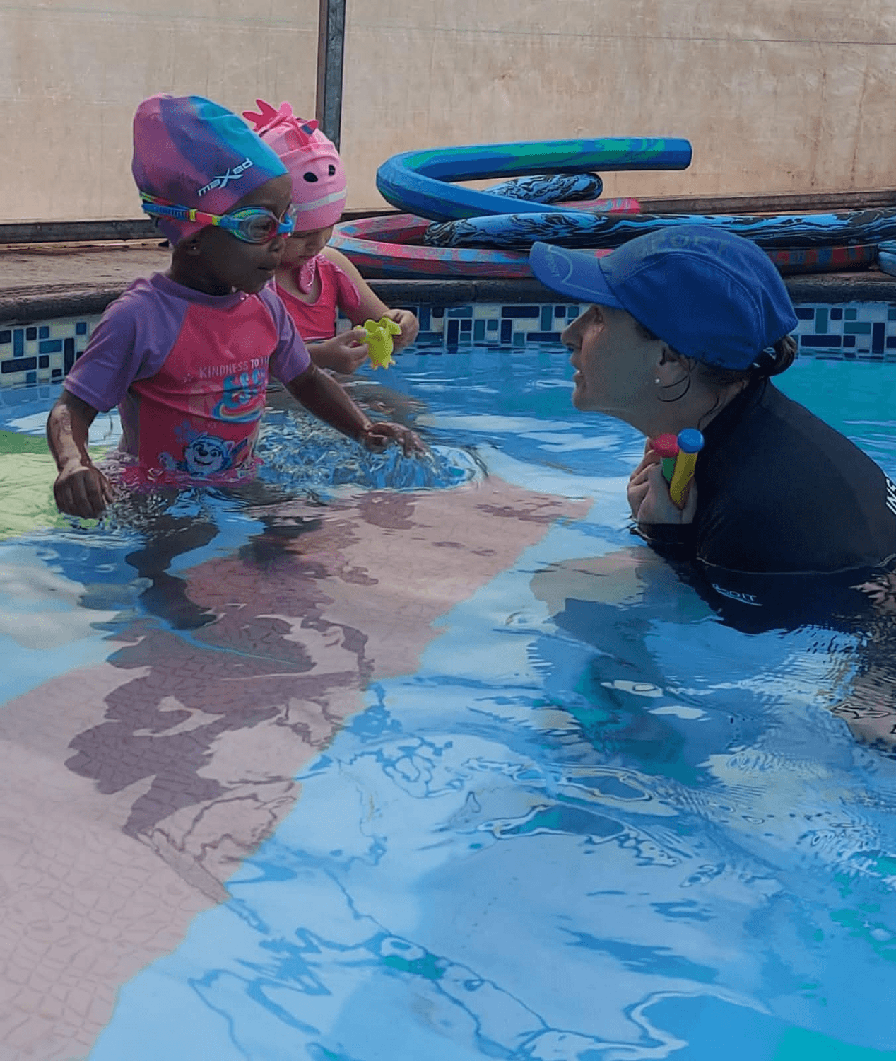Ina teaching two little swimmers in the pool