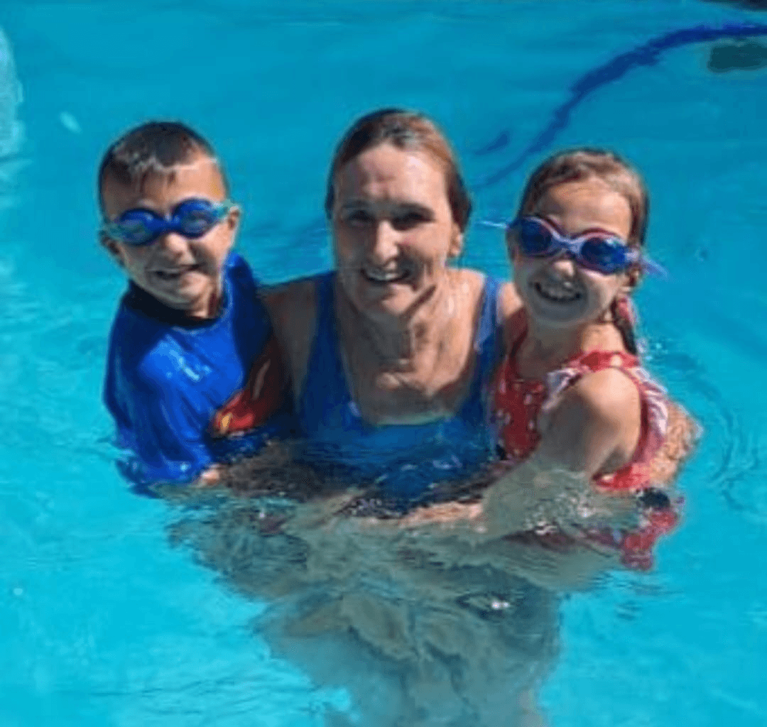 Ina in the pool with two happy young swimmers