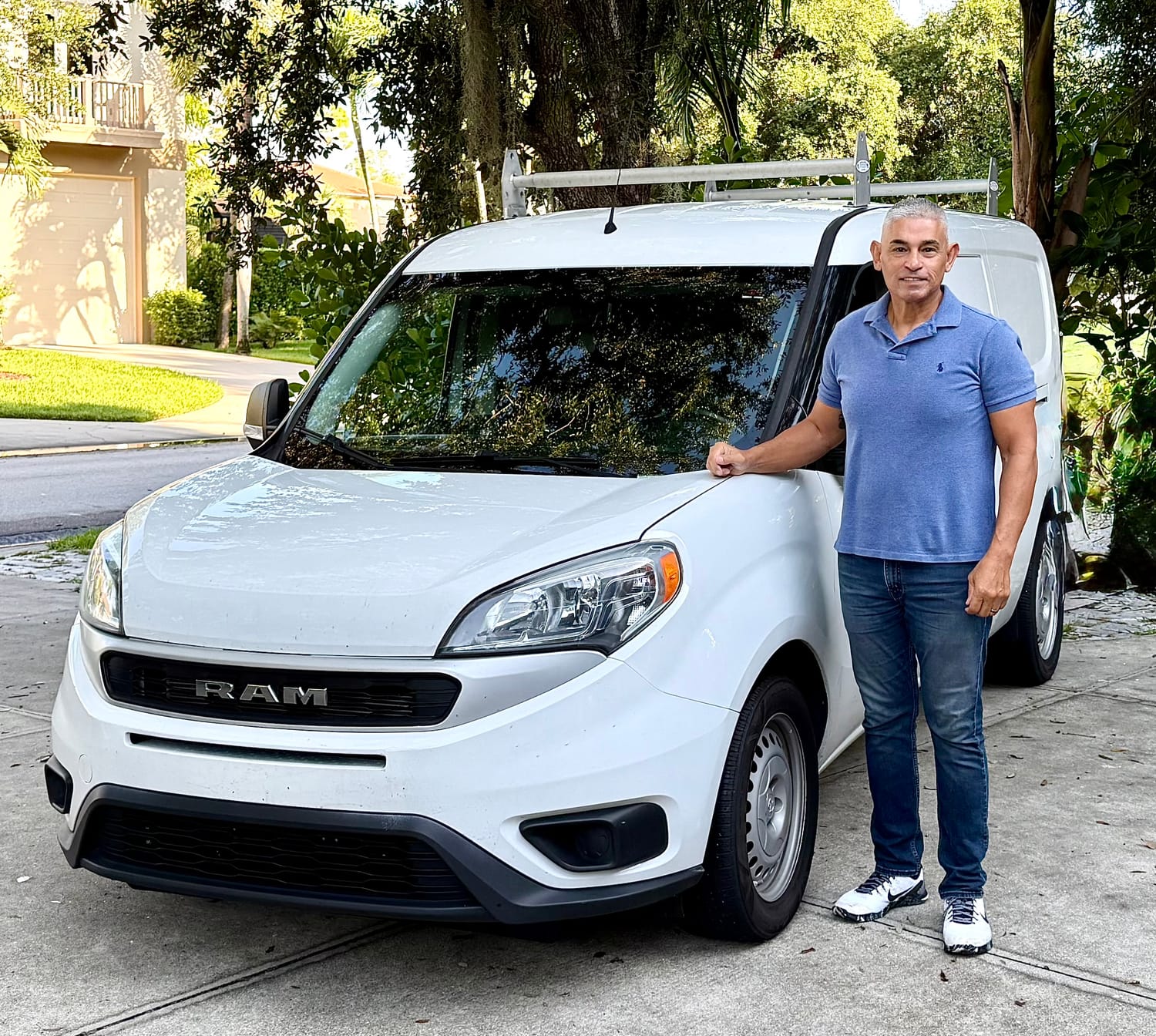 Pablo Rosalez with the Naples Courier delivery van