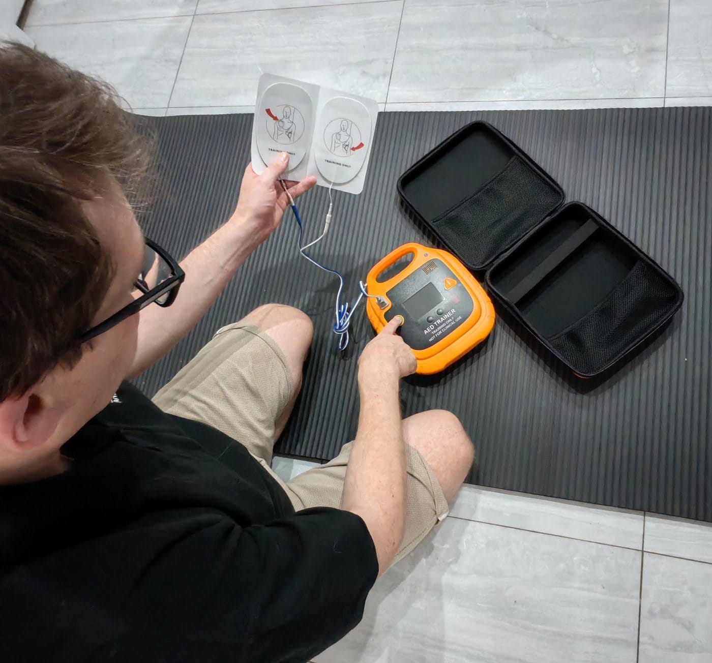 James demonstrating an AED trainer with training pads