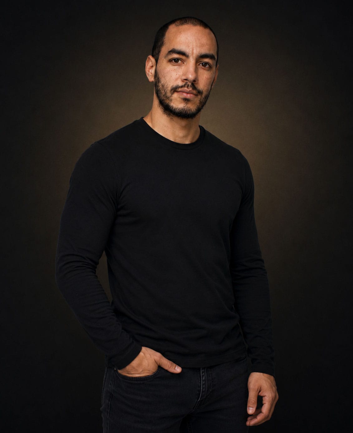 Relic Wessels, relationship coach for entrepreneurs, photographed in a dark studio portrait.