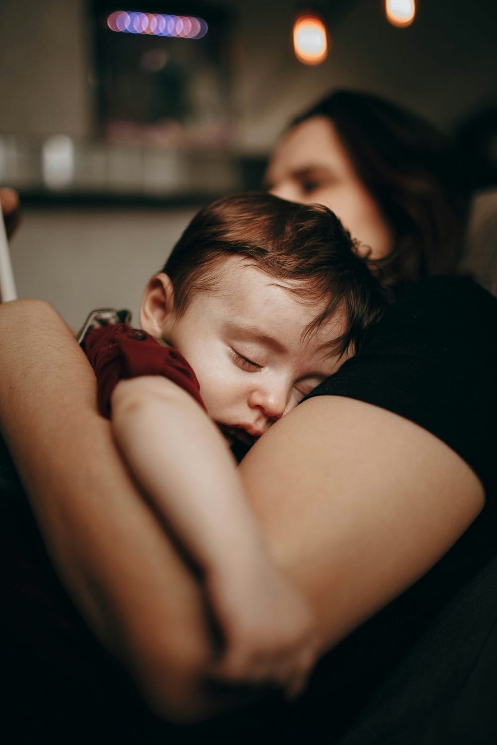 Parent holding a calm baby while using PediaPulse for pediatric guidance
