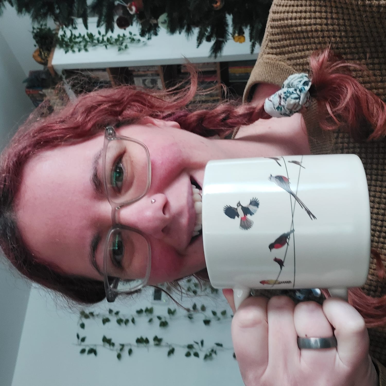 Picture of Jessica smiling and holding a coffee cup