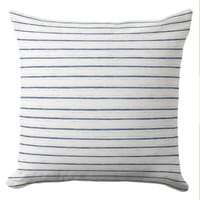 White coastal throw pillow with thin blue stripes in coastal style