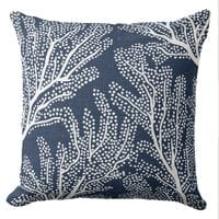 A navy coastal sofa pillow featuring a block print design of sea coral in white
