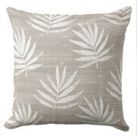 A palm leaf throw pillow in a natural neutral coastal color