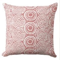 A coral coastal throw pillow featuring a hand block organic pattern in white ink