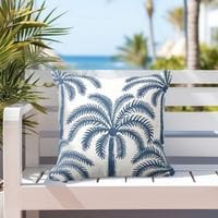 a navy blue and white coastal sofa pillow featuring a modern palm tree pattern
