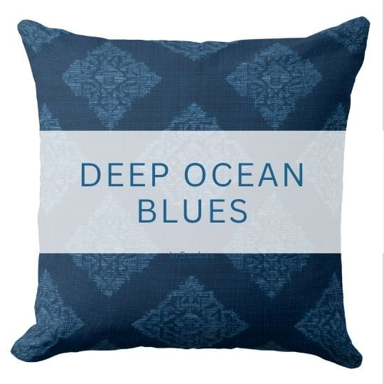 A dark blue throw pillow in a coastal style.