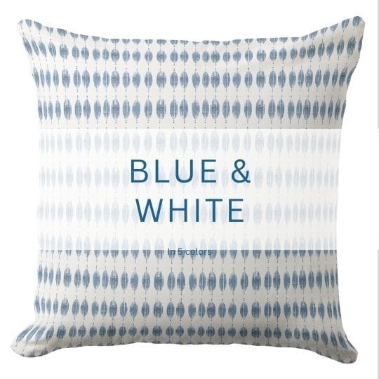 A blue and white throw pillow in a modern coastal style.