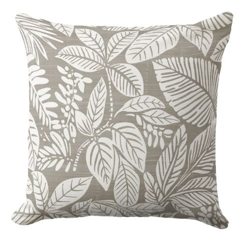 A tropical throw pillow featuring a linen texture look block print style tropical leaves pattern in warm sandy neautral and white.