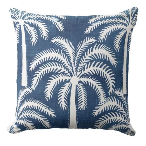 A blue and white throw pillow in a modern coastal style.