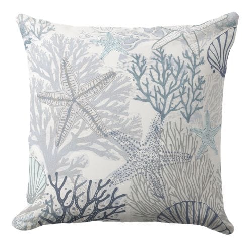 A blue throw pillow in a muted blue hue in a coastal style.